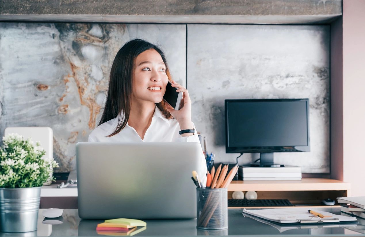 administrative professional talking on the phone and smiling