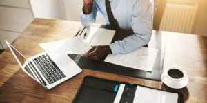 administrative professional tackling year end tasks on office desk