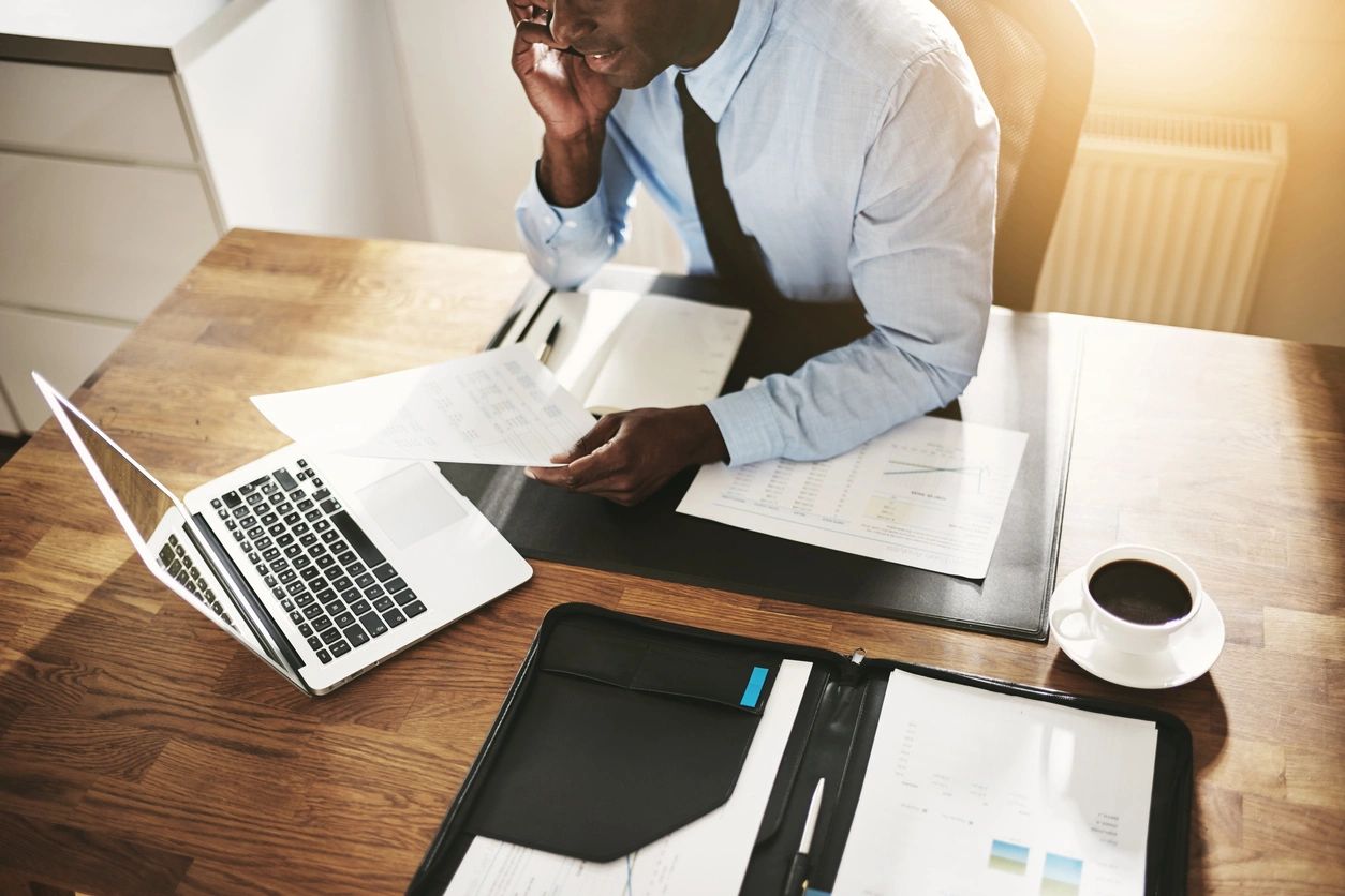 administrative professional tackling year end tasks on office desk