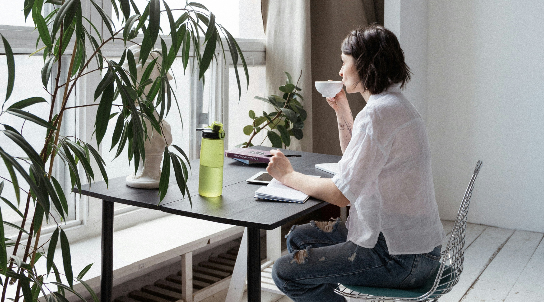 Administrative professional sipping coffee while reflecting on work life balance.